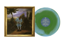 Framed artwork of a person in a landscape next to a green and blue vinyl record with a label.