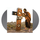 album cover with a Person holding a large wooden speaker system in a desert setting