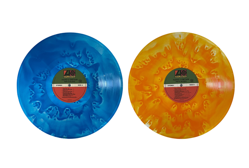 Two vinyl records, one blue and one orange, with labels on a white background.
