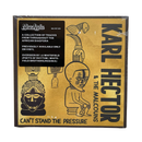 Album cover art for Karl Hector & The Malcouns' 'Can't Stand the Pressure', featuring black tribal and mask illustrations on a textured gold background with a dark brown border.