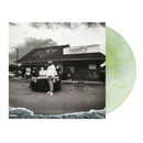 Vinyl record with a black and white photo of a Benny standing in front of a store, with a greenish-yellow disc.