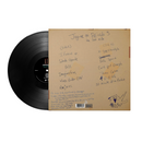 Vinyl record with a custom sleeve featuring handwritten titles on a white background