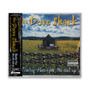 CD cover of 'The Dove Shack' with a cabin in a field and chain fence.