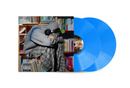 Blush album cover with Blue vinyl records on the side with a person in a gray sweater and plaid pants 