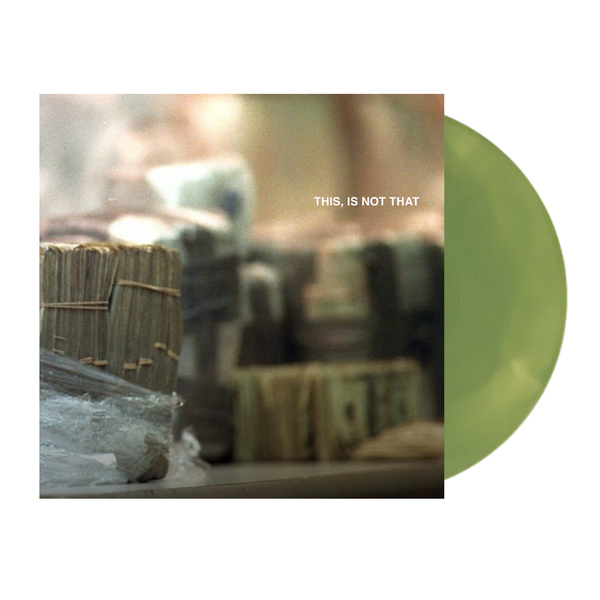 Vinyl record with a robot and text 'THIS IS NOT THAT' on a green background