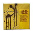 A square graphic design featuring a mustard yellow background with a brown paint splatter and dripped circle. Inside the circle, the brand name 'YARAANDOO' is printed in brown.